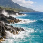 Dramatic Hawaiian volcanic black rock coastline meeting brilliant turquoise water