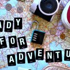 verhead flat lay of road trip planning essentials including a paper map