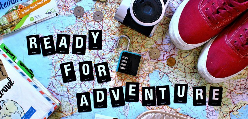 verhead flat lay of road trip planning essentials including a paper map