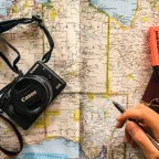 Close-up of a traveler using international map open