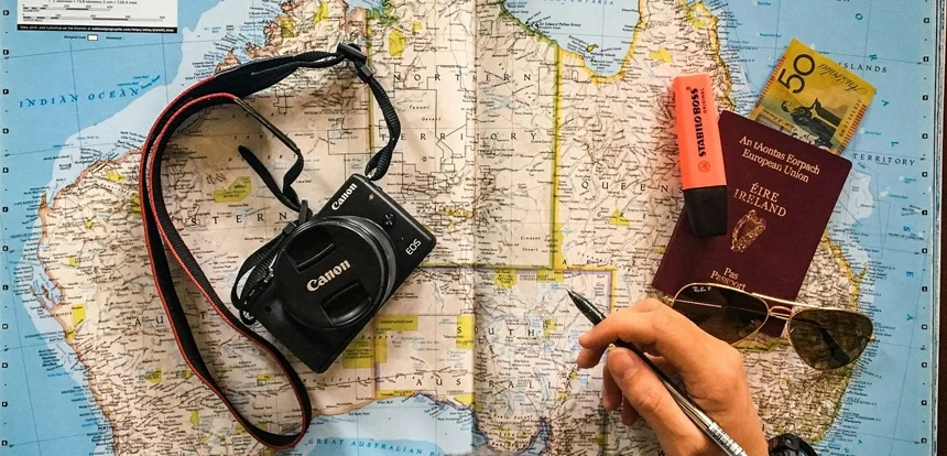 Close-up of a traveler using international map open