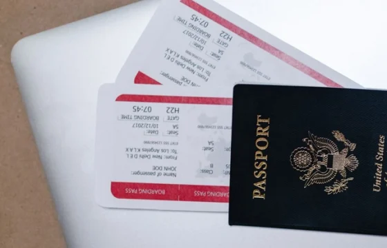 Overhead view of a passport with boarding pass