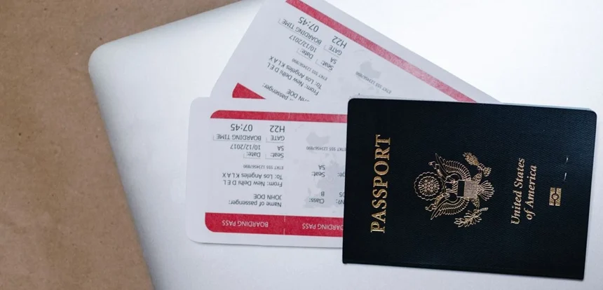 Overhead view of a passport with boarding pass