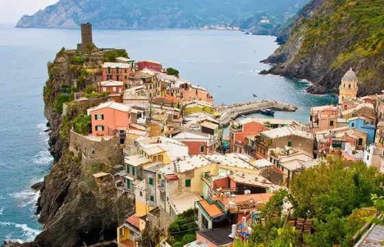 Charming colorful European village with terracotta rooftops, flower-lined cobblestone streets